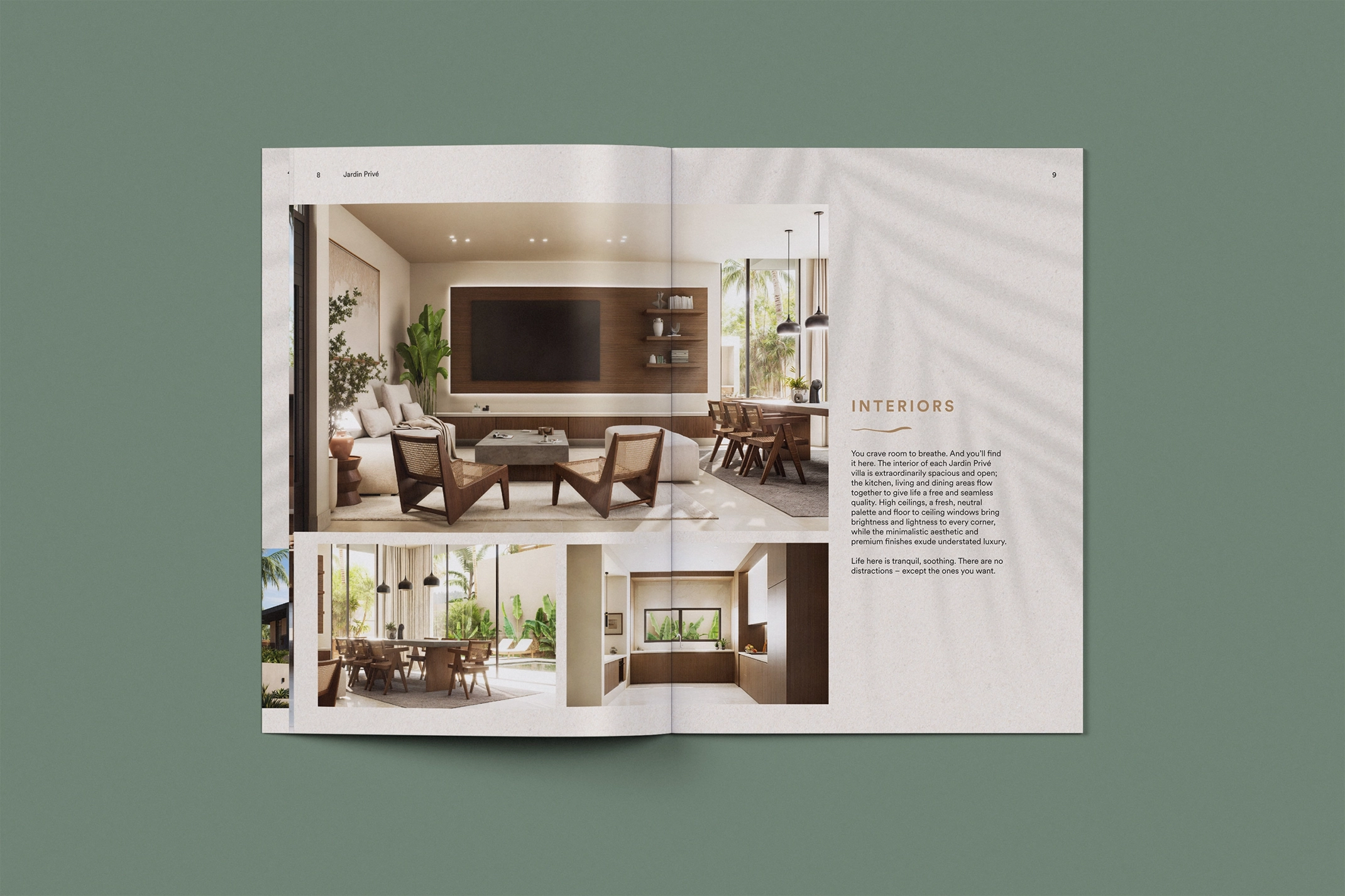 Open spread of the Dune Signature Oasis brochure, featuring photographs of villa interior spaces. The top photograph shows a living area with a sofa, armchairs, a television, and a dining table. The bottom left photograph shows a dining area with a table and chairs, and a view of the outdoor patio. The bottom right photograph shows a kitchen counter with a sink and cabinets. The text 'INTERIORS' is visible at the top right, followed by paragraphs of descriptive text. A faint palm tree shadow pattern is visible on the right page. The brochure is shown at an angle on a grey-green background. This image showcases the luxury property brochure design, using interior photography and a clean layout to highlight the villas' living spaces and design details.